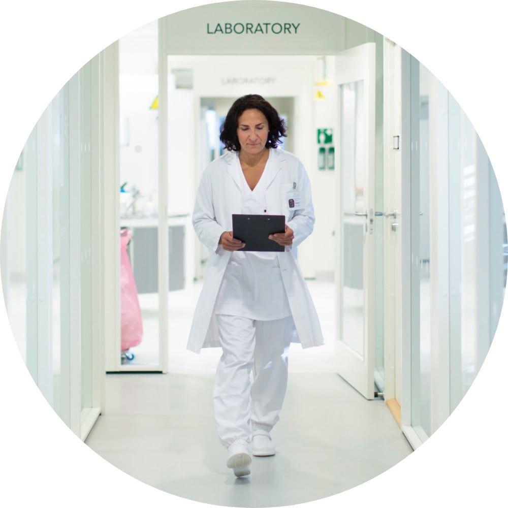 Healthcare professional walking down hospital corridor
